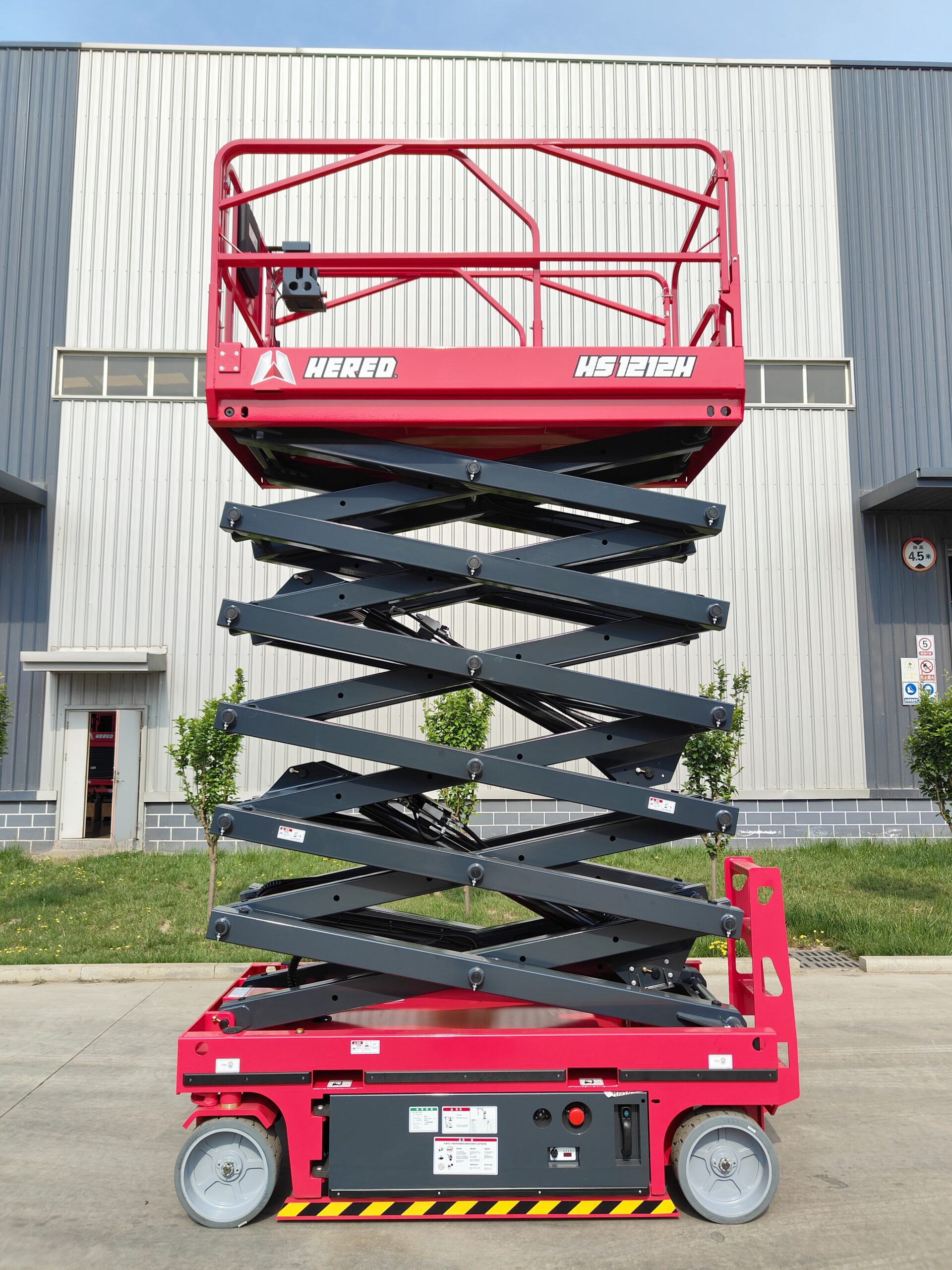 Red HERED HS1212H hydraulic-drive electric scissor lift in stowed position