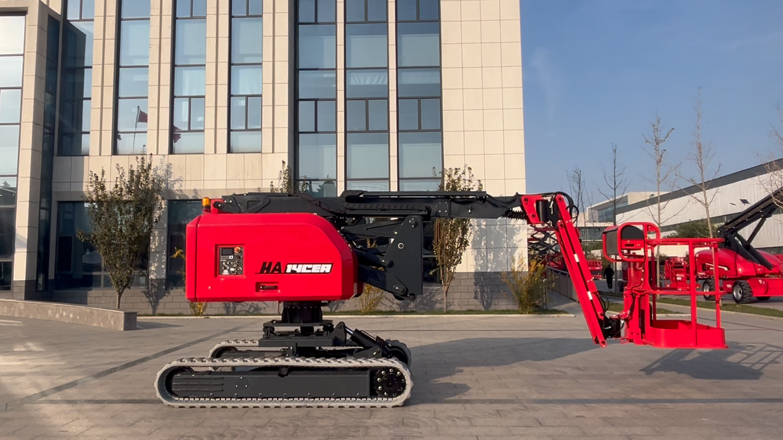 Red HERED HA12CEA crawler articulating boom lift in stowed position