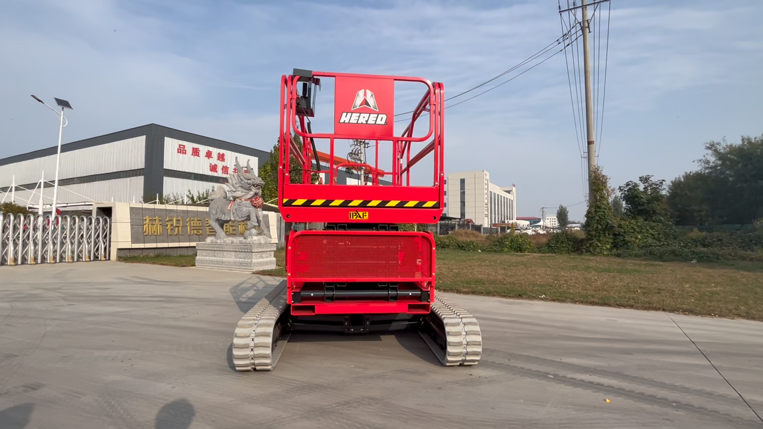 Red HERED HC1018EA auto-levelling crawler scissor lift in stowed position