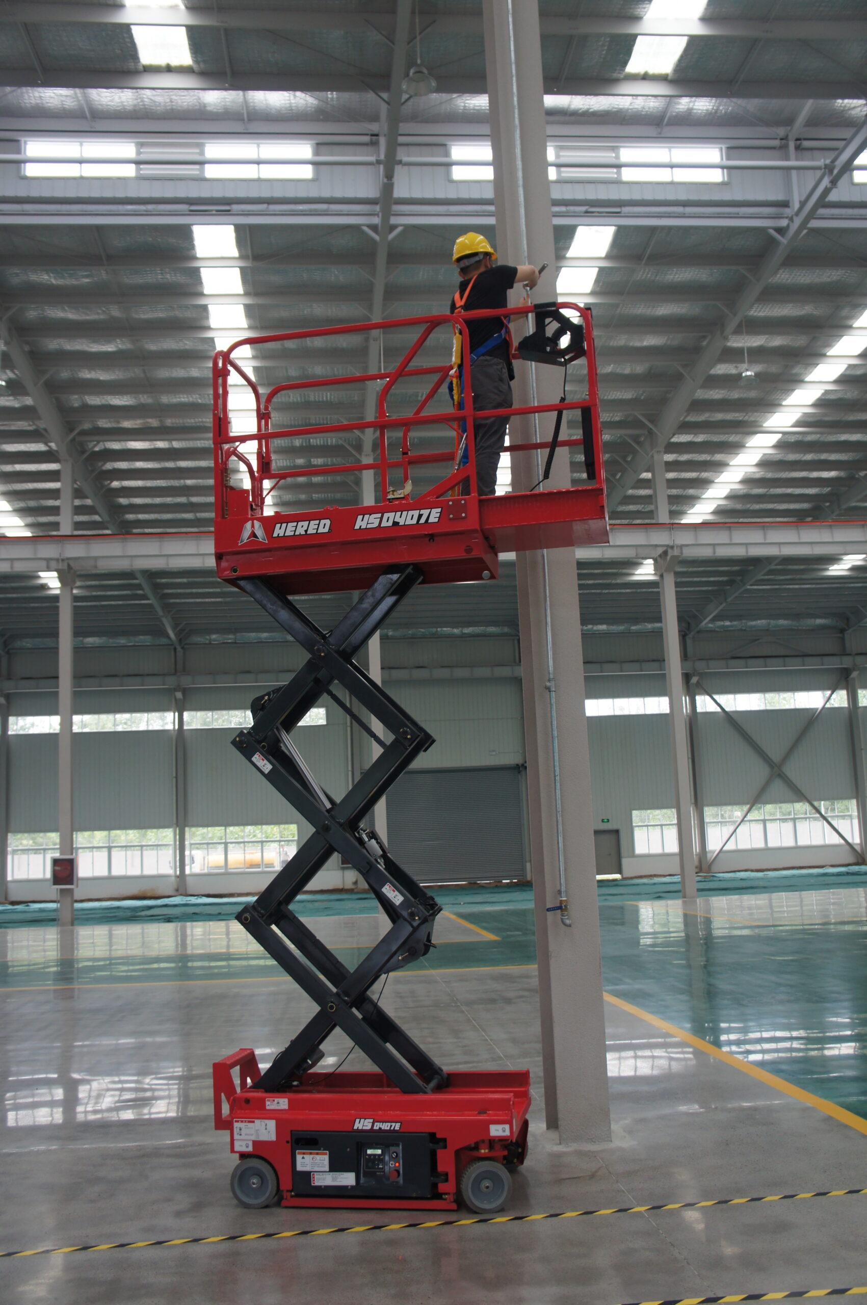Red HERED HS0407E electric slab scissor lift in stowed position indoors