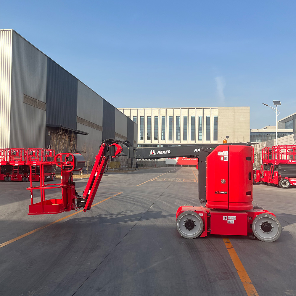 Red HERED HA09RJE articulating boom lift in stowed position, side view