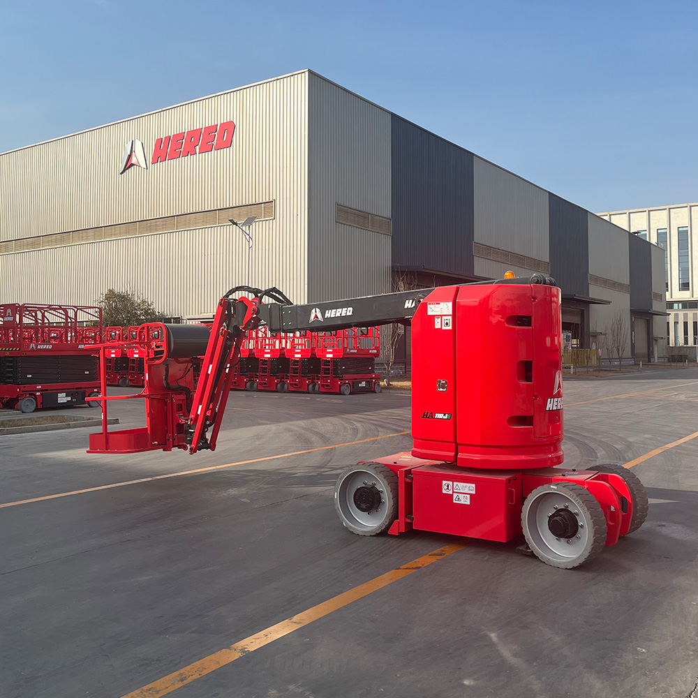 Red HERED HA09RJE articulating boom lift in stowed position, side view