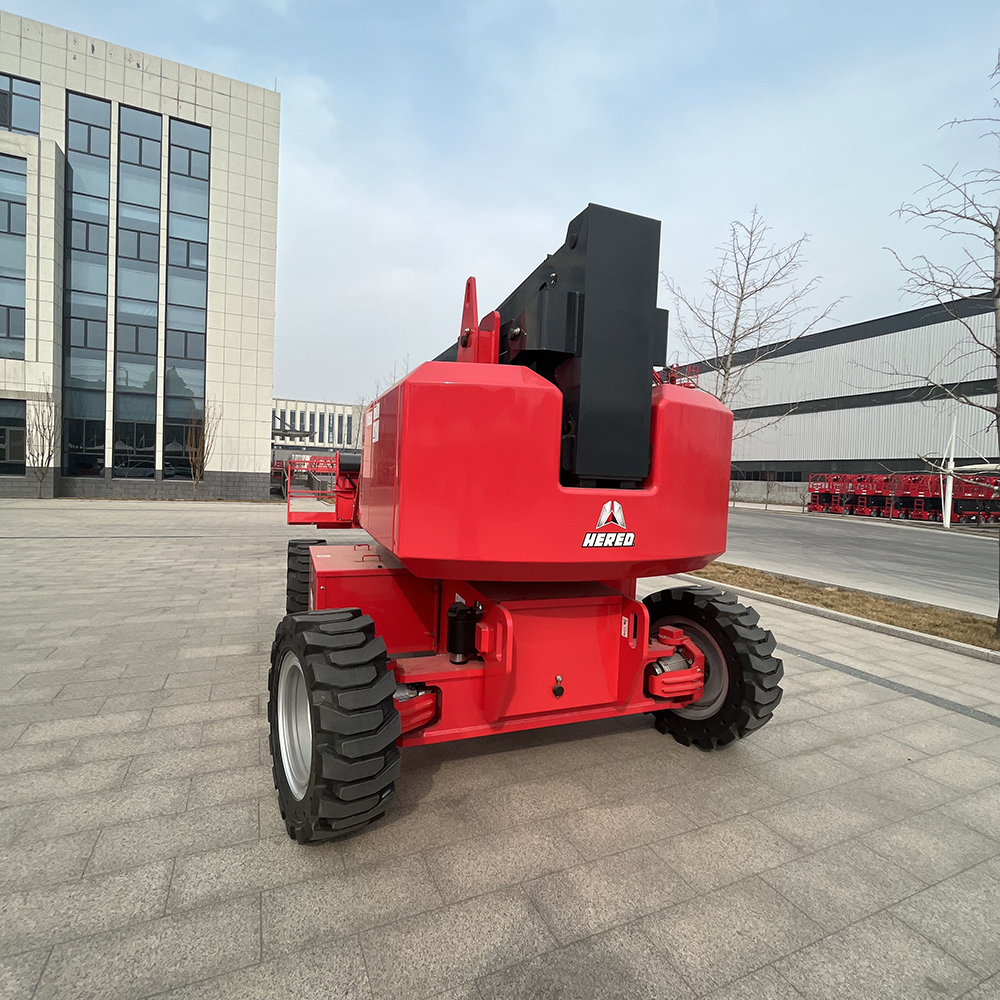 Red HERED HA21JE articulating boom lift in stowed position, rear view