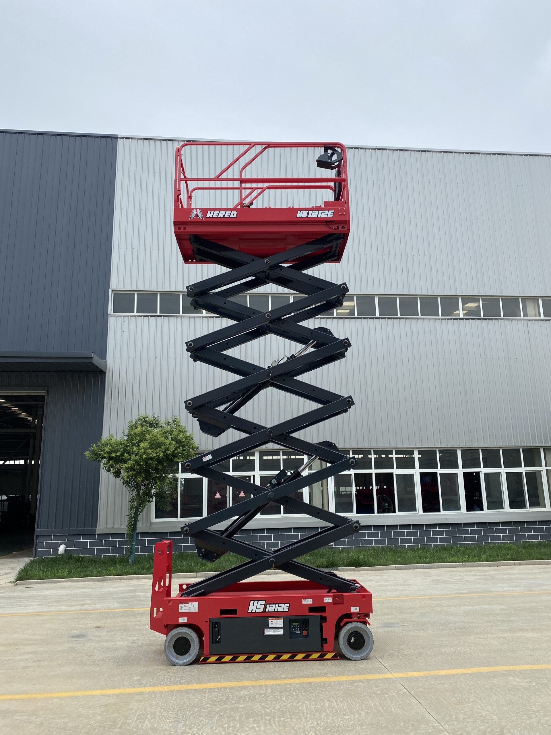 Red HERED HS1212E electric slab scissor lift in stowed position