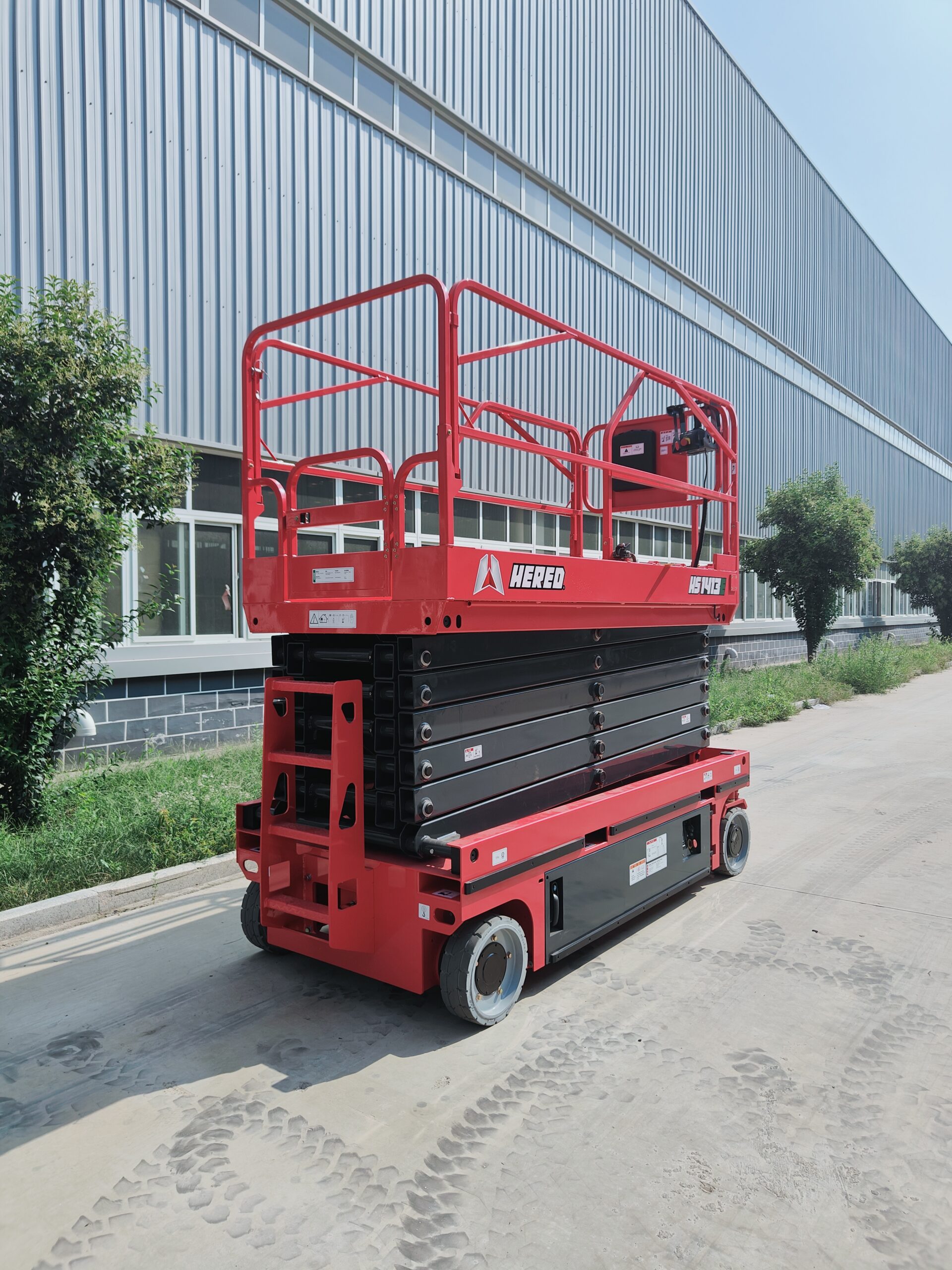 Red HERED HS1413E electric slab scissor lift in stowed position