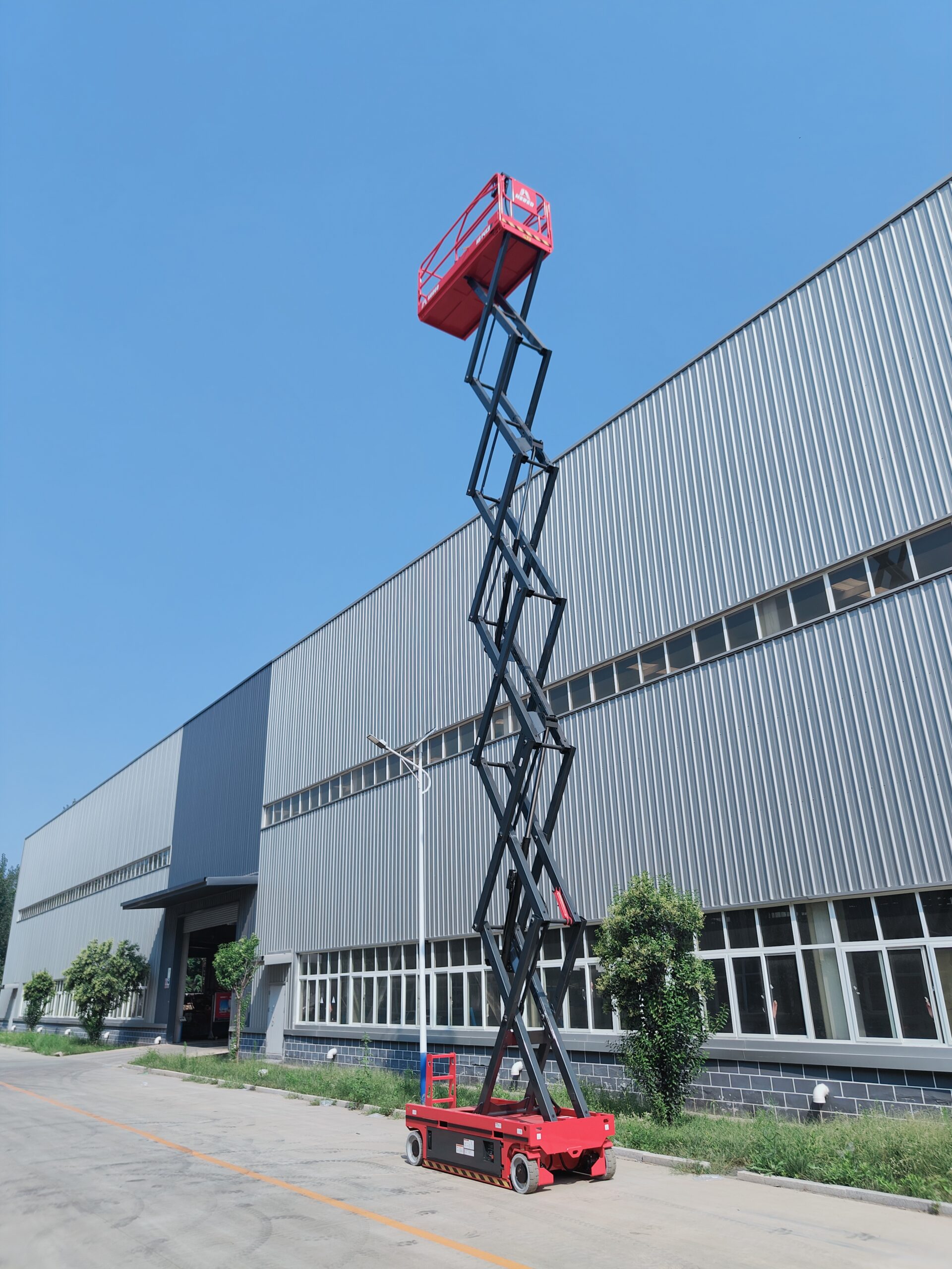 Red HERED HS1413E electric slab scissor lift in stowed position