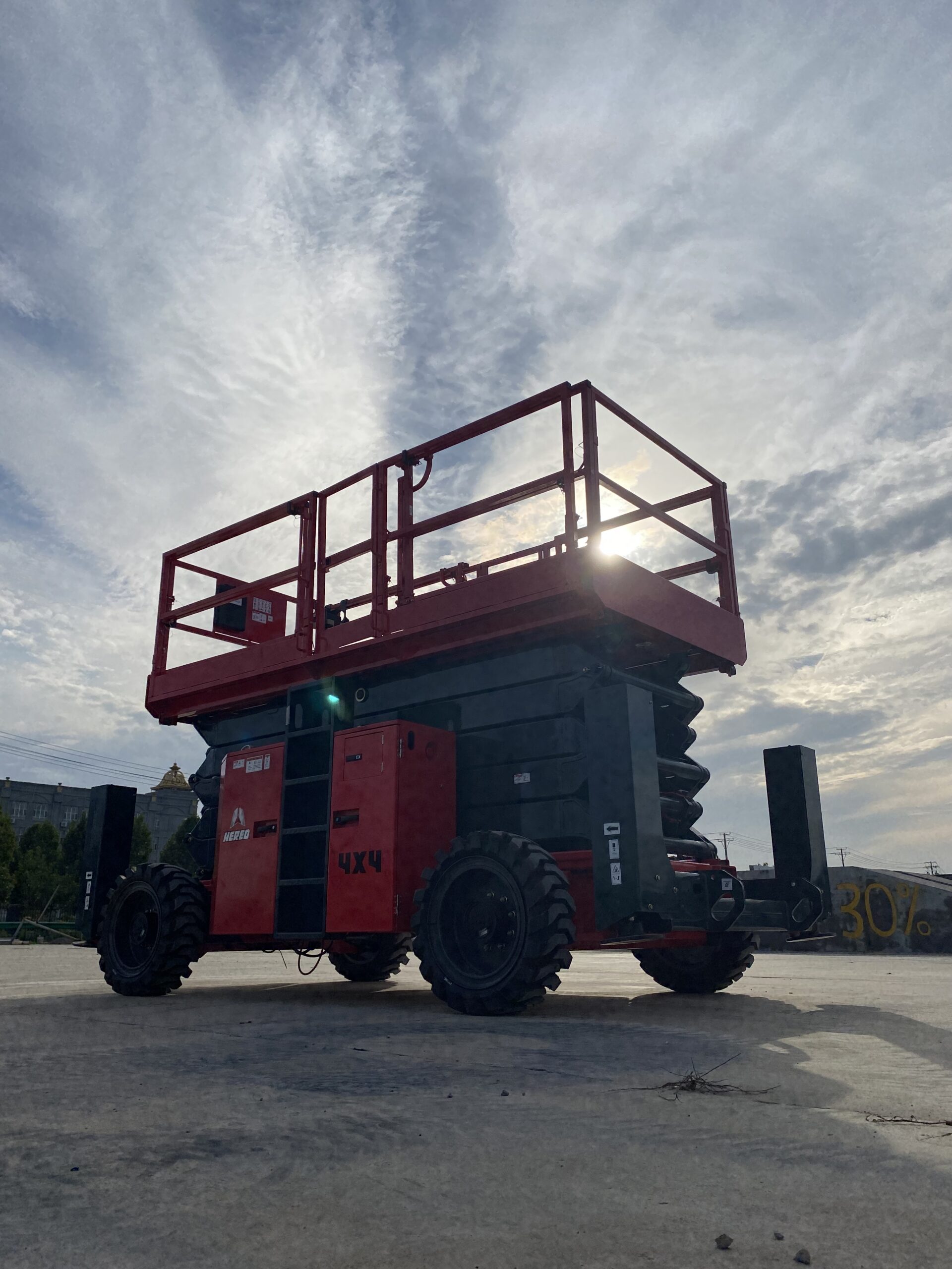 Red HERED HS1623RT rough-terrain scissor lift in stowed position