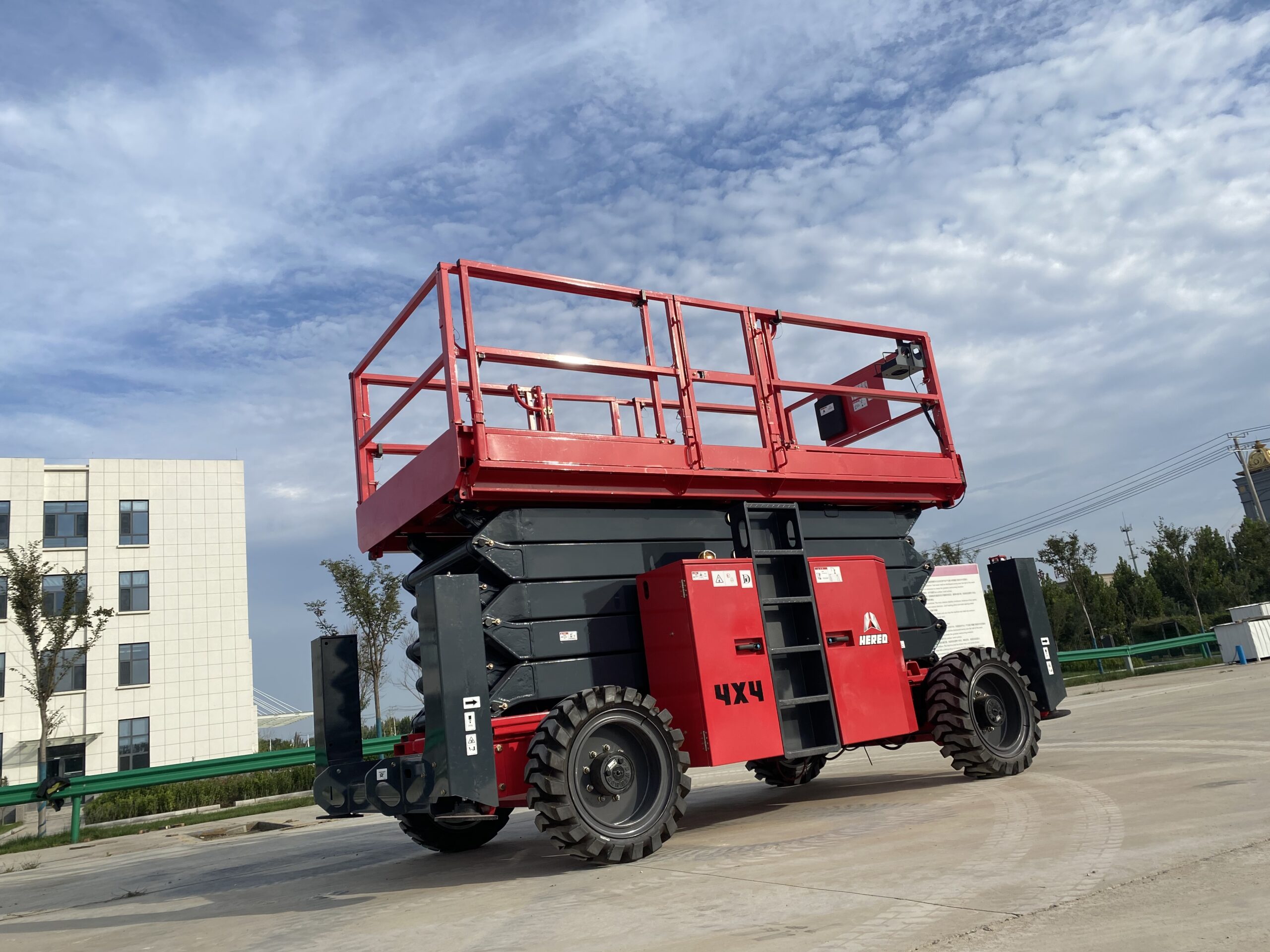Red HERED HS1623RT rough-terrain scissor lift in stowed position
