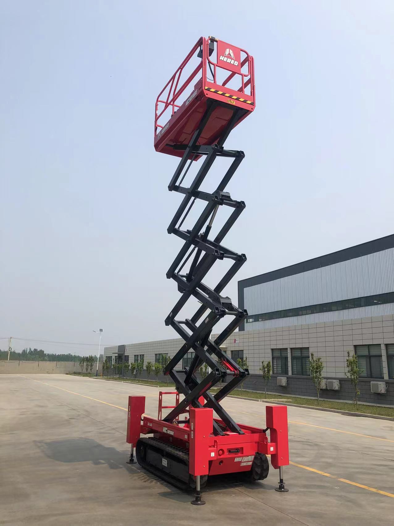 Red HERED HC1216E crawler scissor lift in stowed position