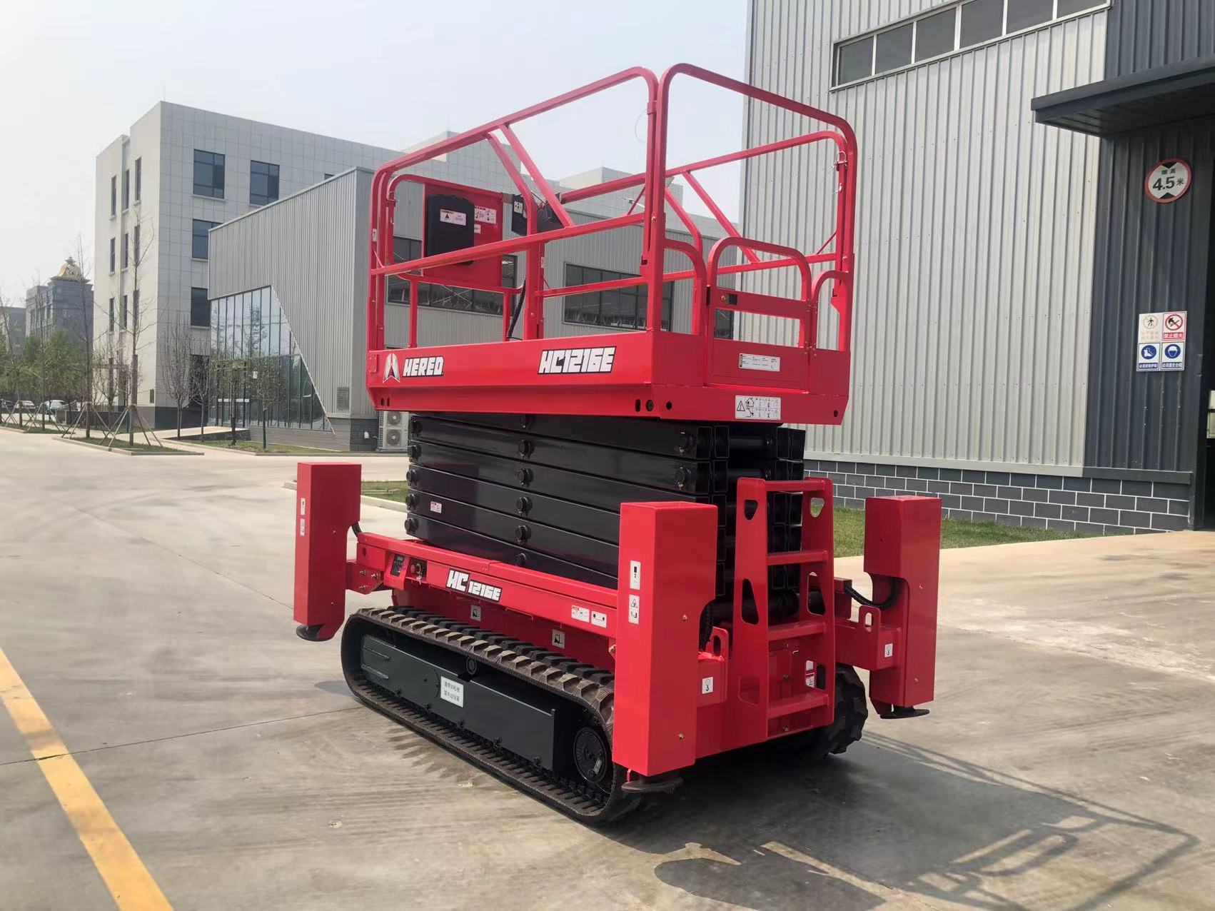 Red HERED HC1216E crawler scissor lift in stowed position