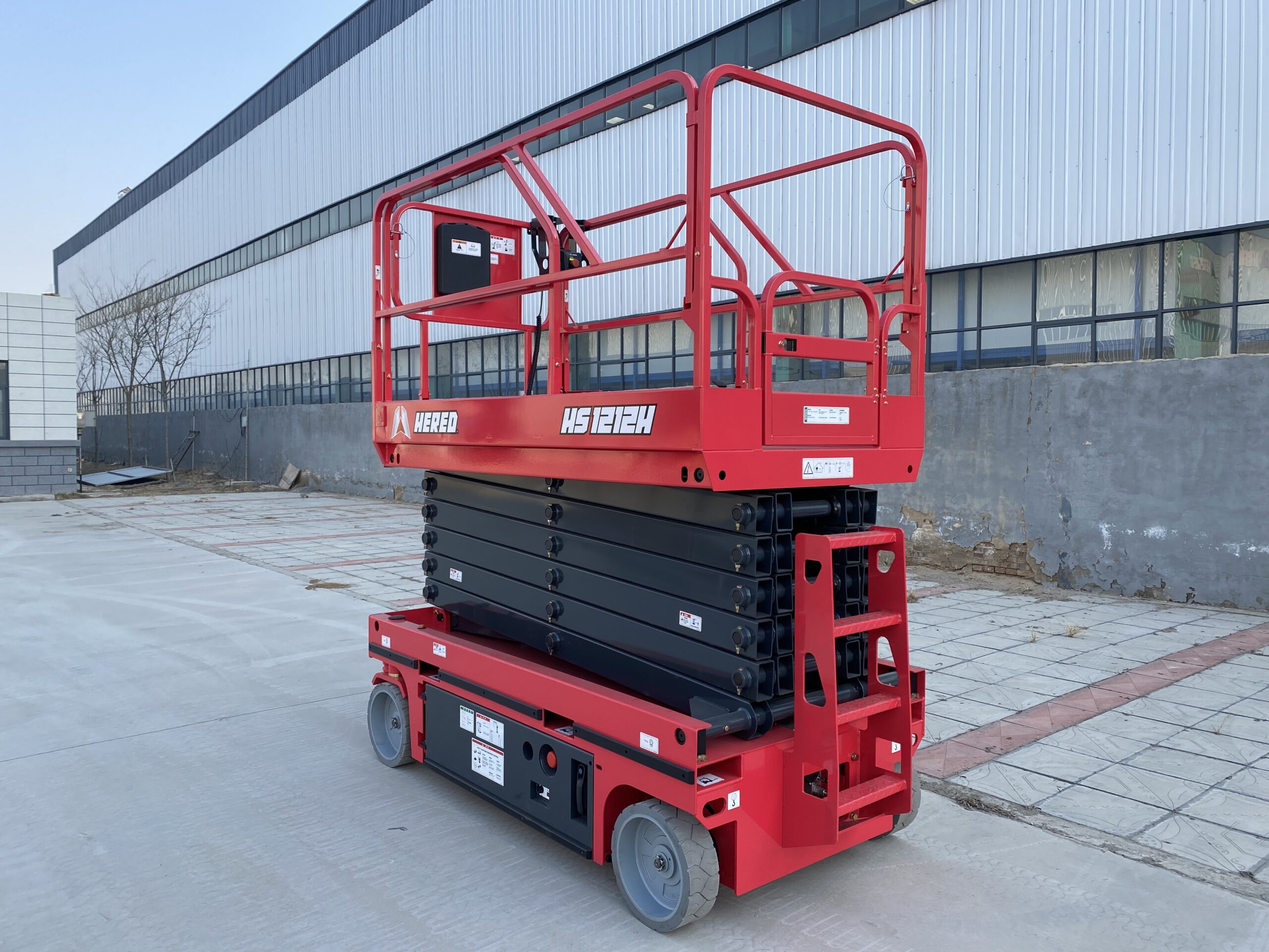 Red HERED HS1212H hydraulic-drive electric scissor lift in stowed position